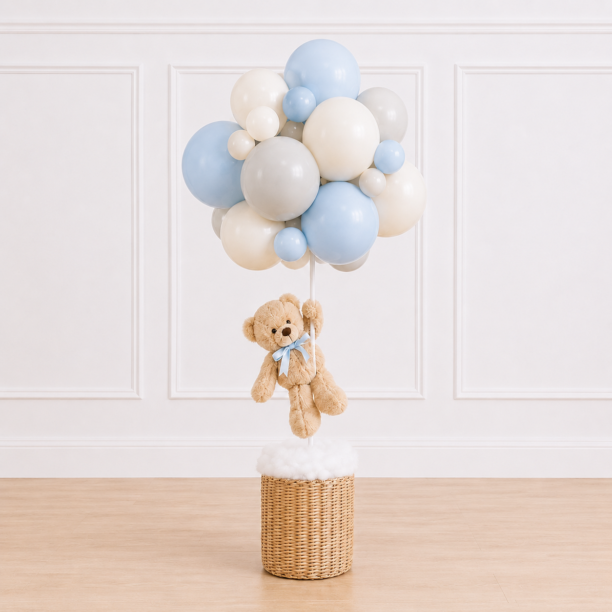 Luxury teddy bear balloon basket centerpiece featuring a plush teddy bear, woven wicker basket, and customizable organic balloon cluster for baby showers by Cedarwood Events.