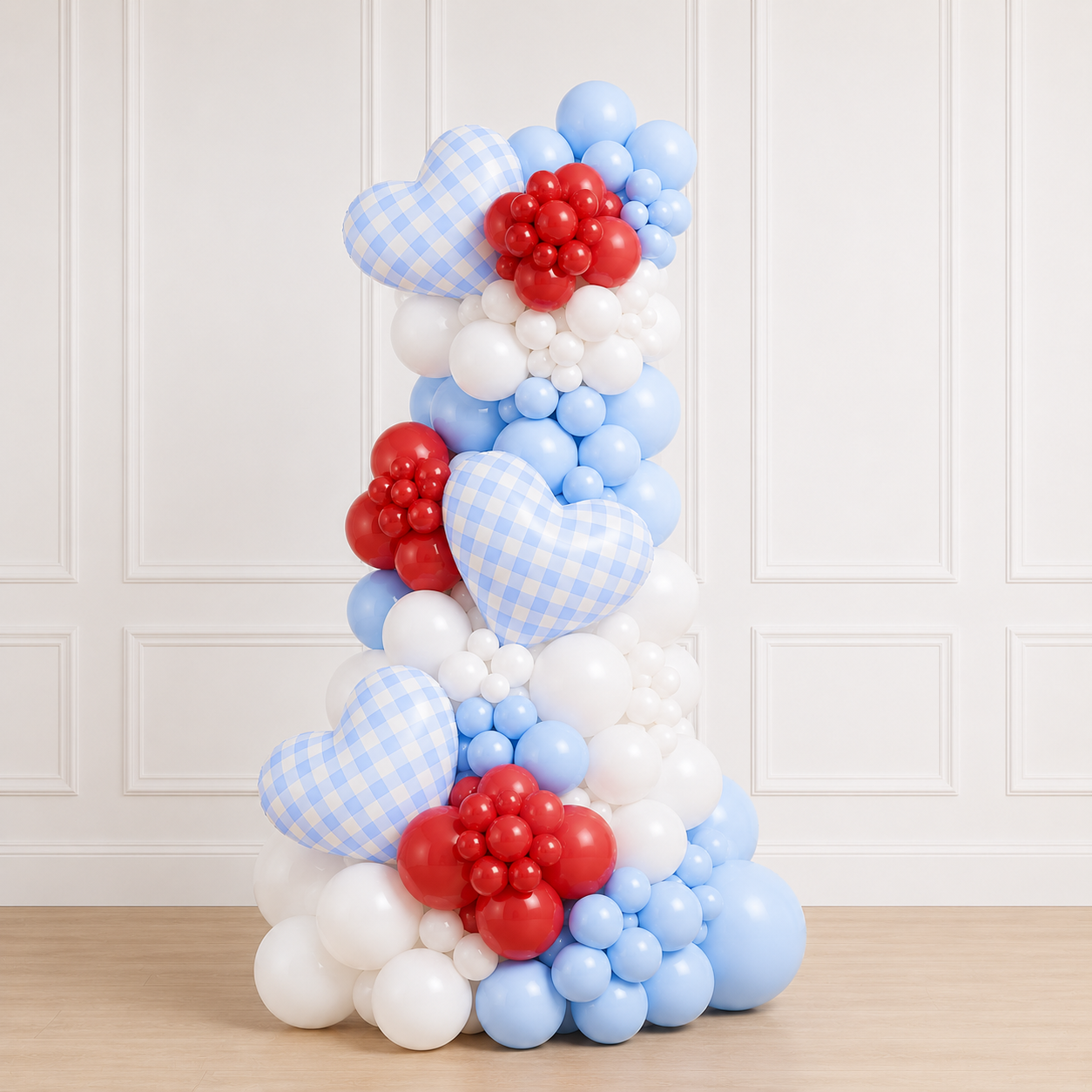 Signature She’s Ready to Pop™ 6.5ft luxury organic balloon column featuring baby blue, white, and red balloons with gingham heart balloons and floral balloon clusters for a baby shower celebration.