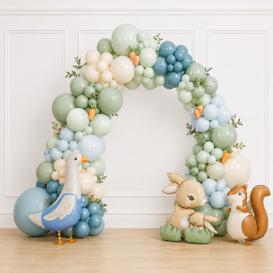 Cedarwood Events organic balloon arch in powder blue, sage green, and cream with woodland animal foil balloons and greenery.